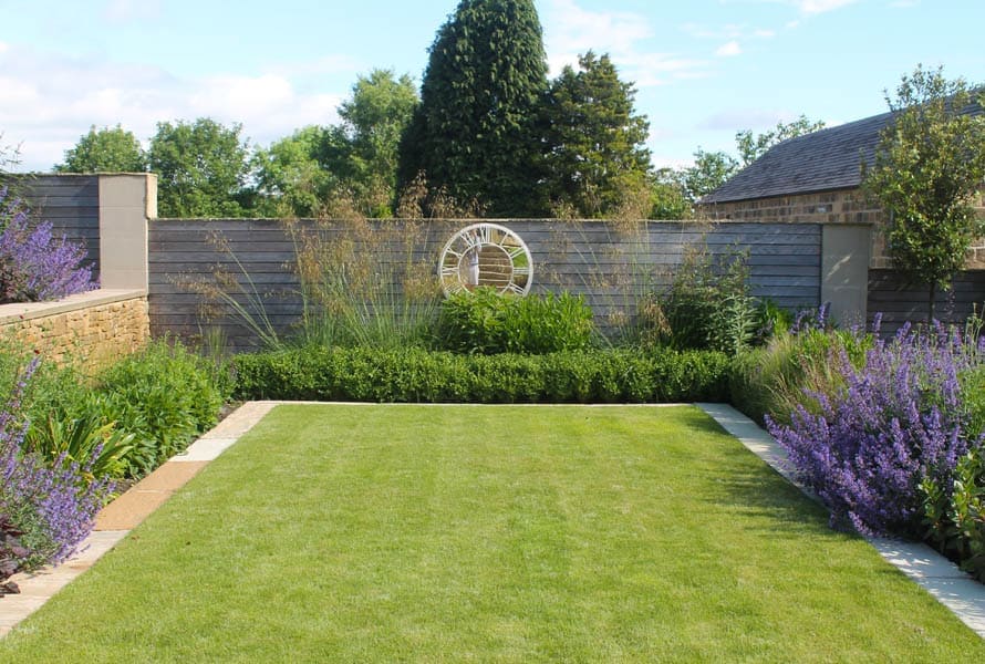 Modern terraced garden with level lawns and colourful planting