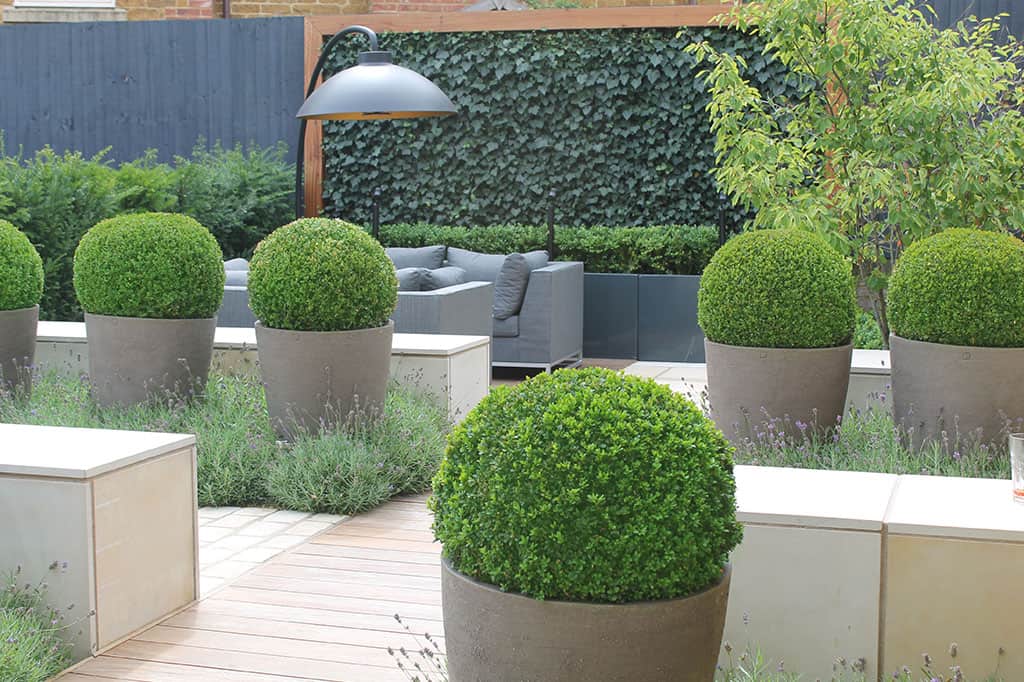 Beautiful outdoor rooms with all weather sofas. Contemporary planting design make for a cosy place to relax