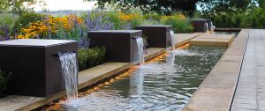why you should & shouldn't buy a water feature - row of fountain cubes. Garden by Bestall & Co.